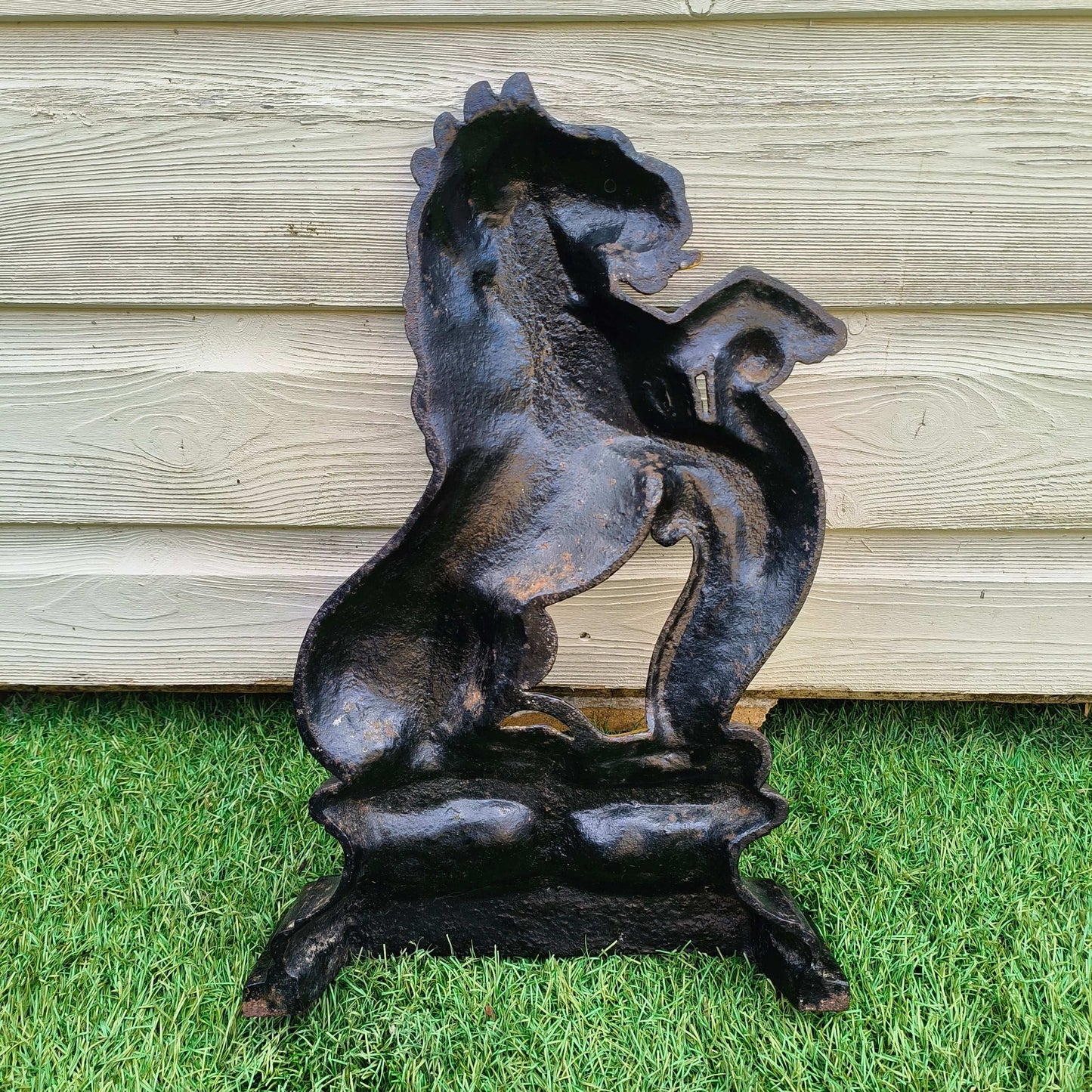 Victorian cast iron lion rampant doorstop in black and gold on stepped base