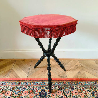 Antique Victorian gypsy table with red velvet octagonal top and ebonized bobbin turned legs