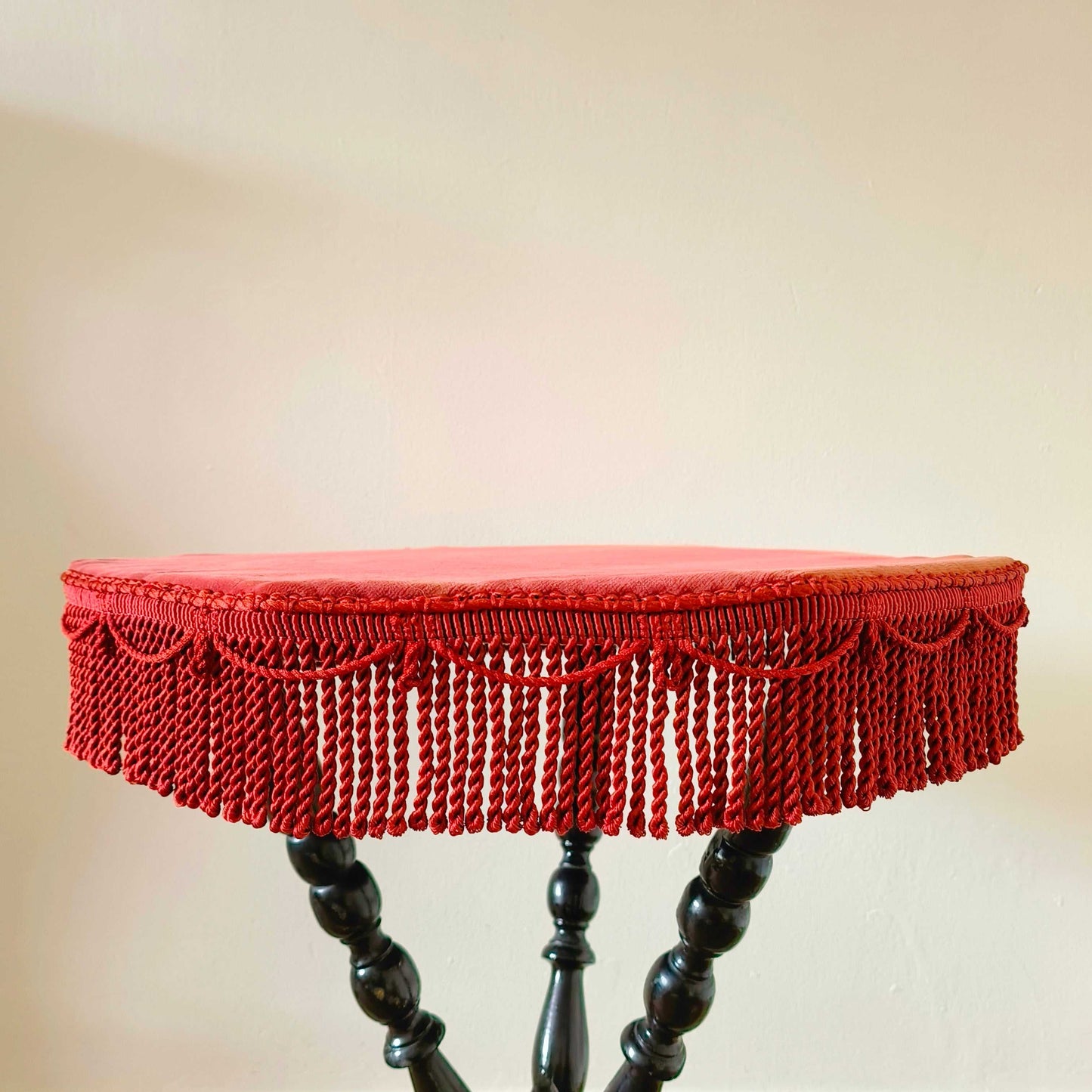 Antique Victorian gypsy table with red velvet octagonal top and ebonized bobbin turned legs