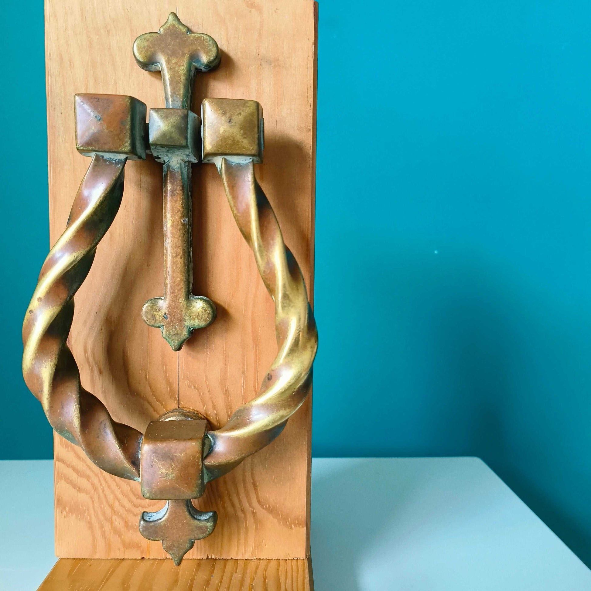 Large Gothic style brass door knocker with twisted ring design and rich patina finish