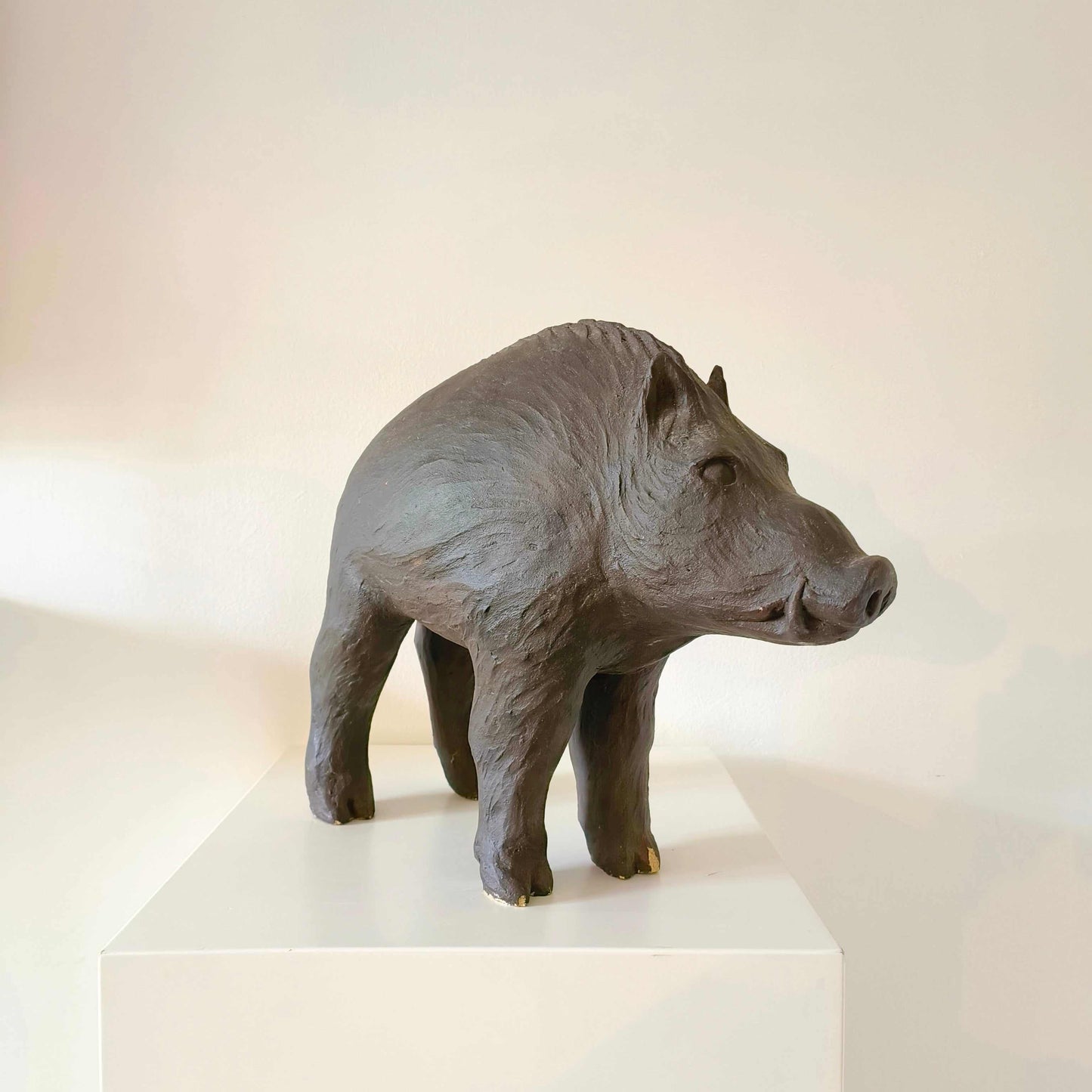 Vintage Italian wild boar statue carved from sandstone with brown patina, mid-century rustic décor piece