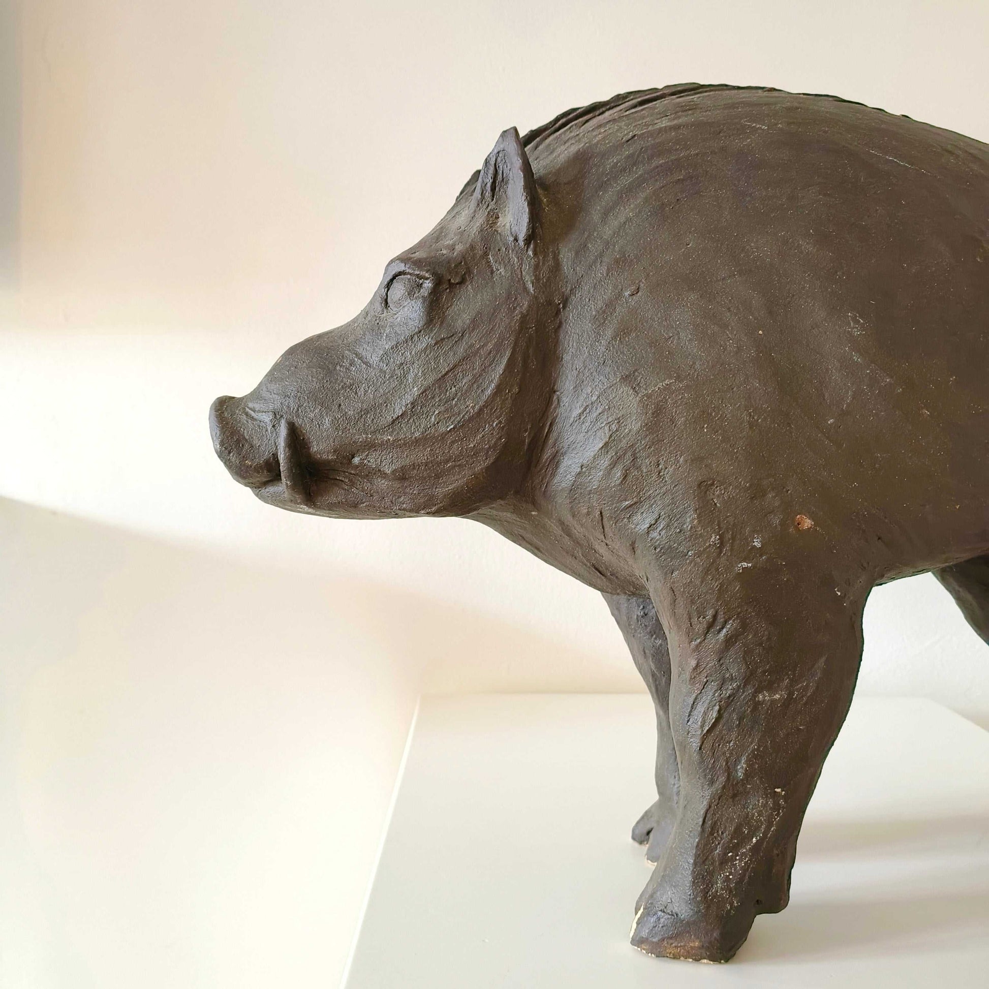 Vintage Italian wild boar statue carved from sandstone with brown patina, mid-century rustic décor piece