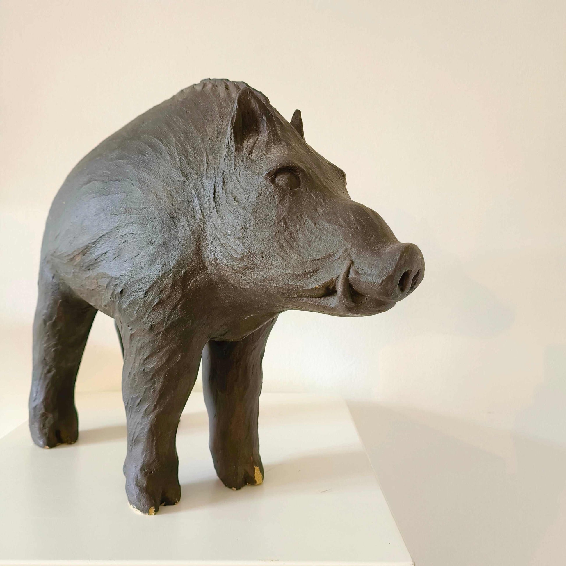 Vintage Italian wild boar statue carved from sandstone with brown patina, mid-century rustic décor piece