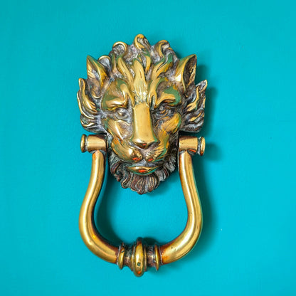 Victorian brass lion head door knocker with detailed lion face and ring handle