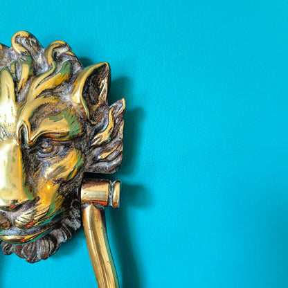 Victorian brass lion head door knocker with detailed lion face and ring handle