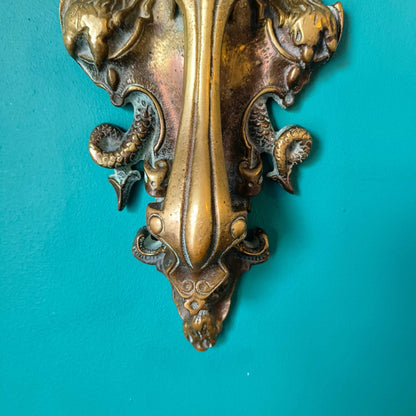 Early Victorian brass door knocker featuring three-headed Cerberus design in solid brass