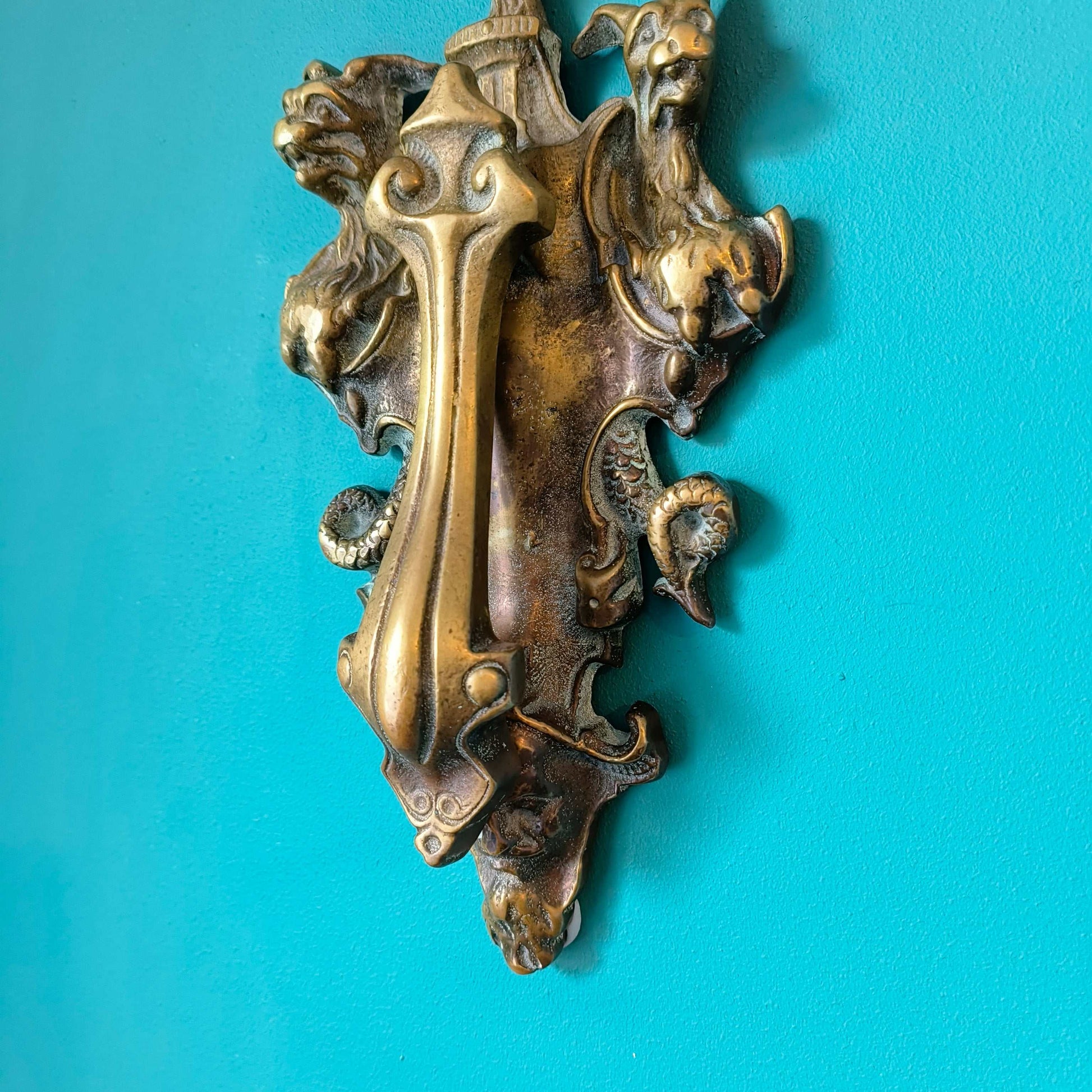 Early Victorian brass door knocker featuring three-headed Cerberus design in solid brass
