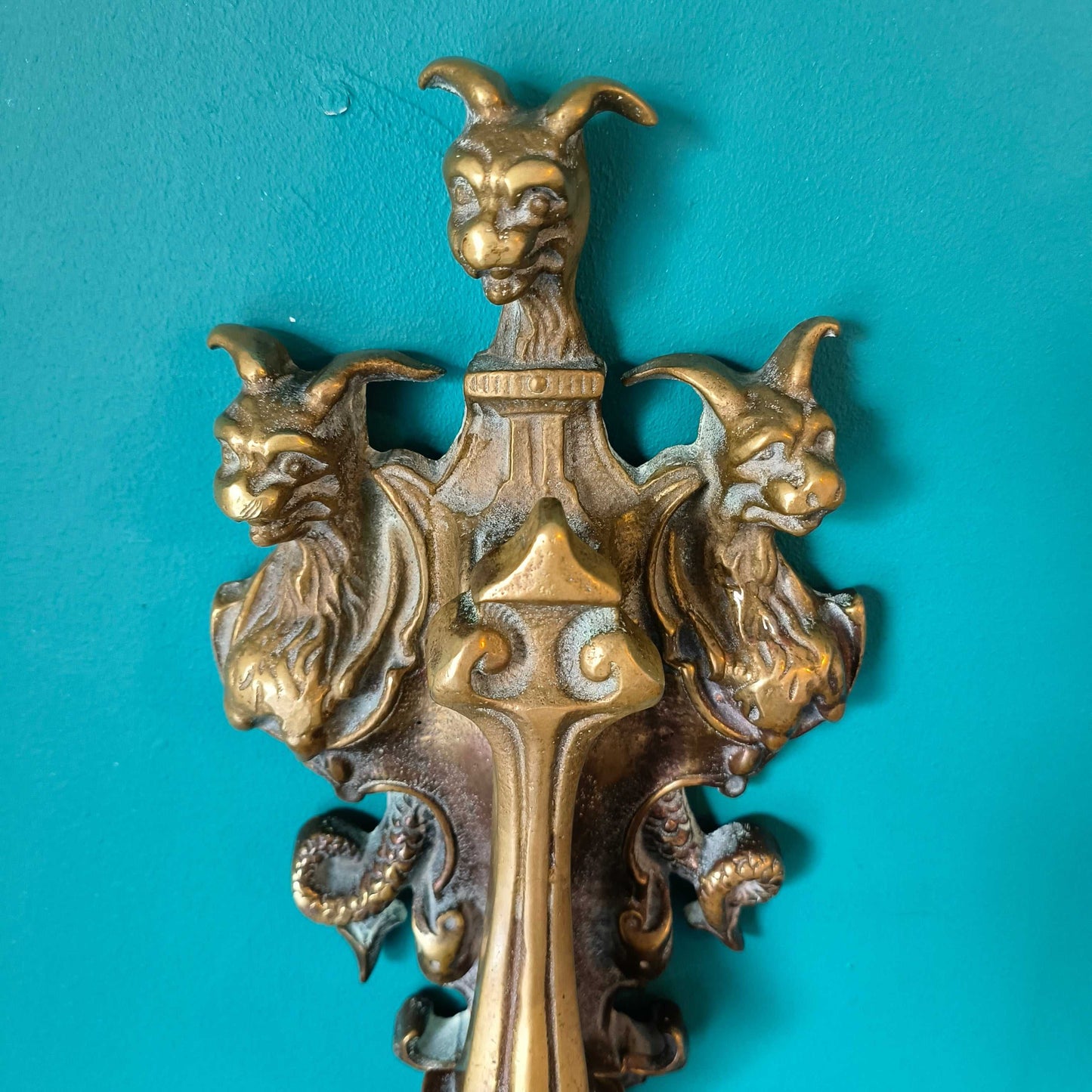 Early Victorian brass door knocker featuring three-headed Cerberus design in solid brass