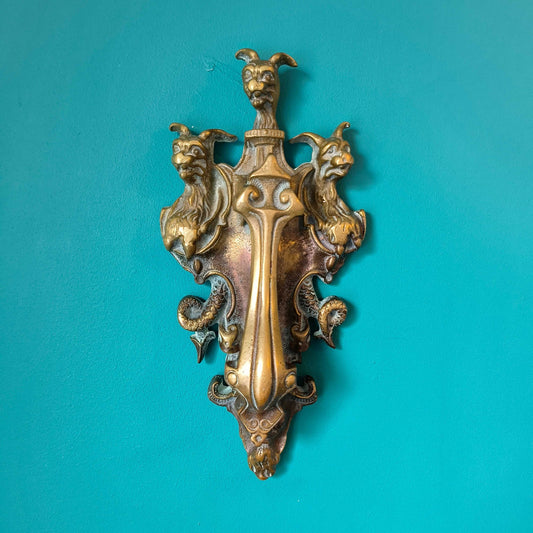 Early Victorian brass door knocker featuring three-headed Cerberus design in solid brass