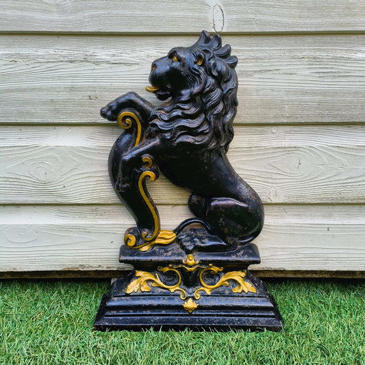 Victorian cast iron lion rampant doorstop in black and gold on stepped base