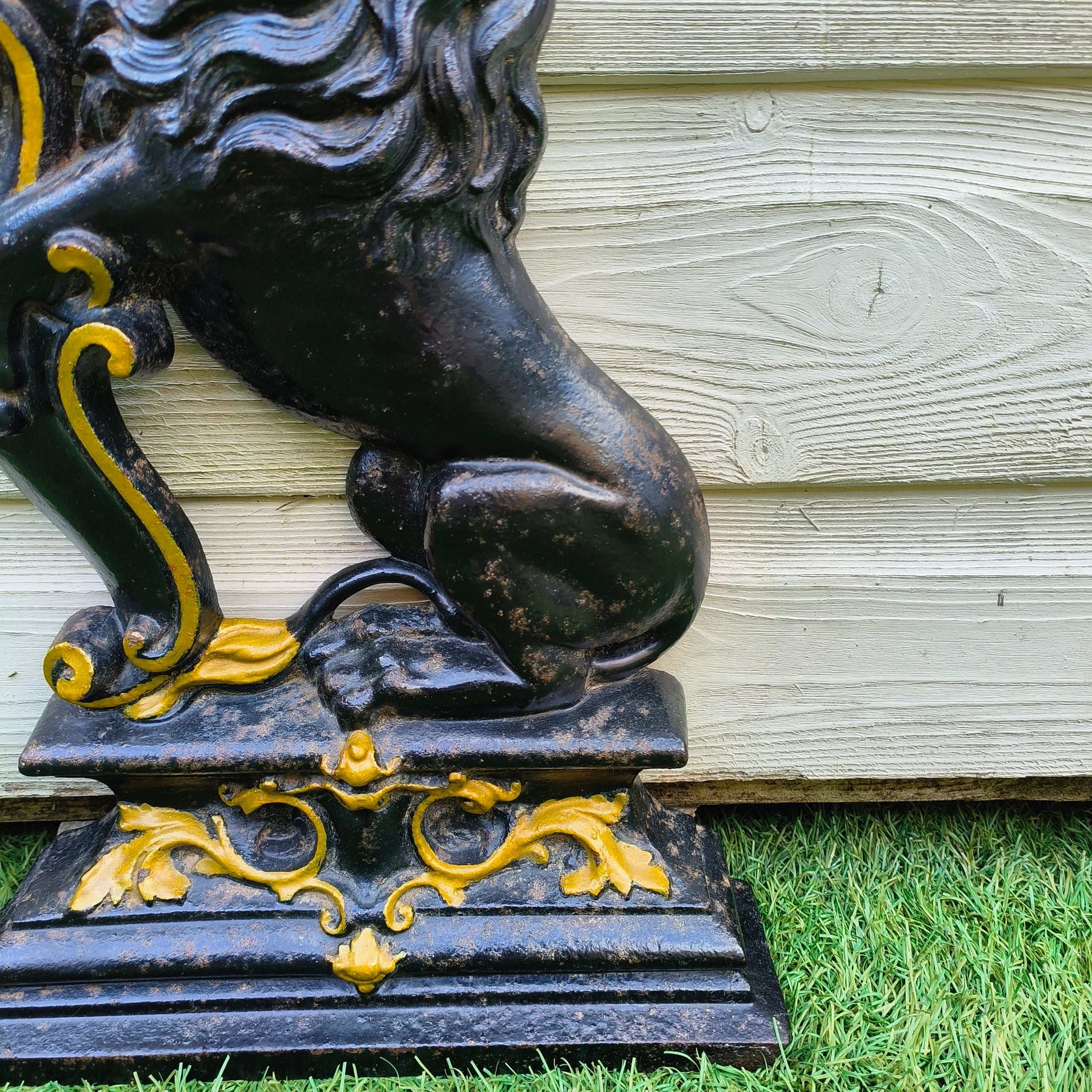 Victorian cast iron lion rampant doorstop in black and gold on stepped base
