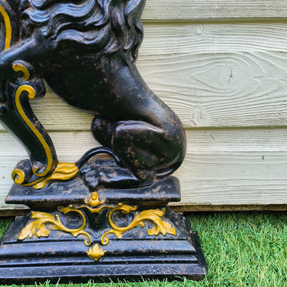 Victorian cast iron lion rampant doorstop in black and gold on stepped base