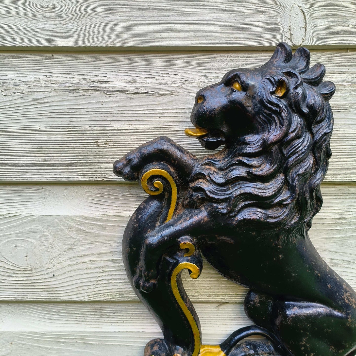 Victorian cast iron lion rampant doorstop in black and gold on stepped base