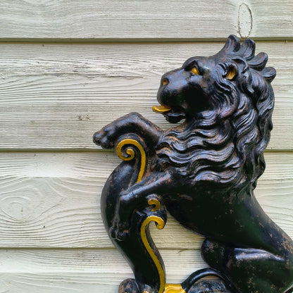 Victorian cast iron lion rampant doorstop in black and gold on stepped base