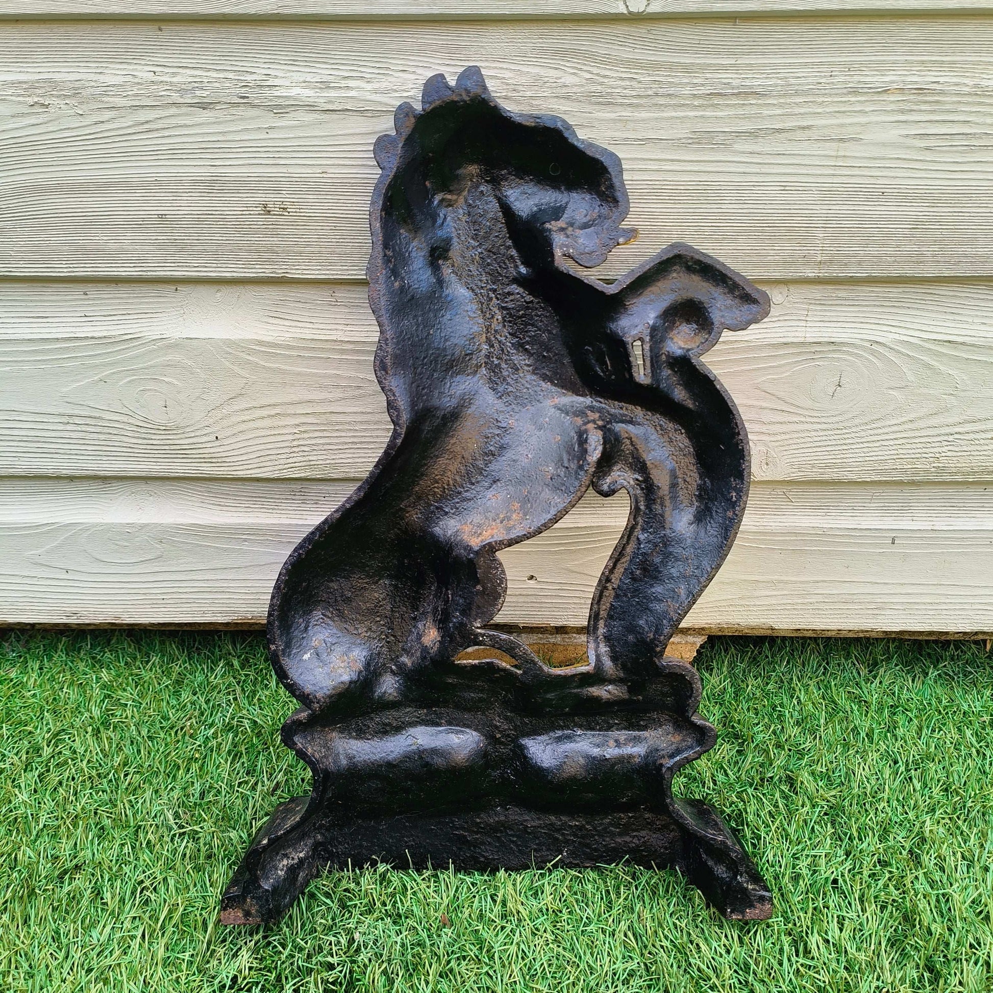 Victorian cast iron lion rampant doorstop in black and gold on stepped base