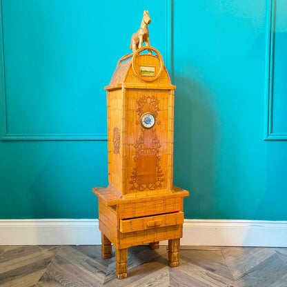 Likely German Mid-century. Constructed from matchsticks with a working clock and a drawer at the base.
Features a decorative horse figure on the very top.
Intricate jail-style folk Art.