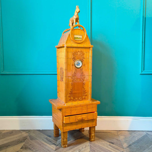 Likely German Mid-century. Constructed from matchsticks with a working clock and a drawer at the base.
Features a decorative horse figure on the very top.
Intricate jail-style folk Art.