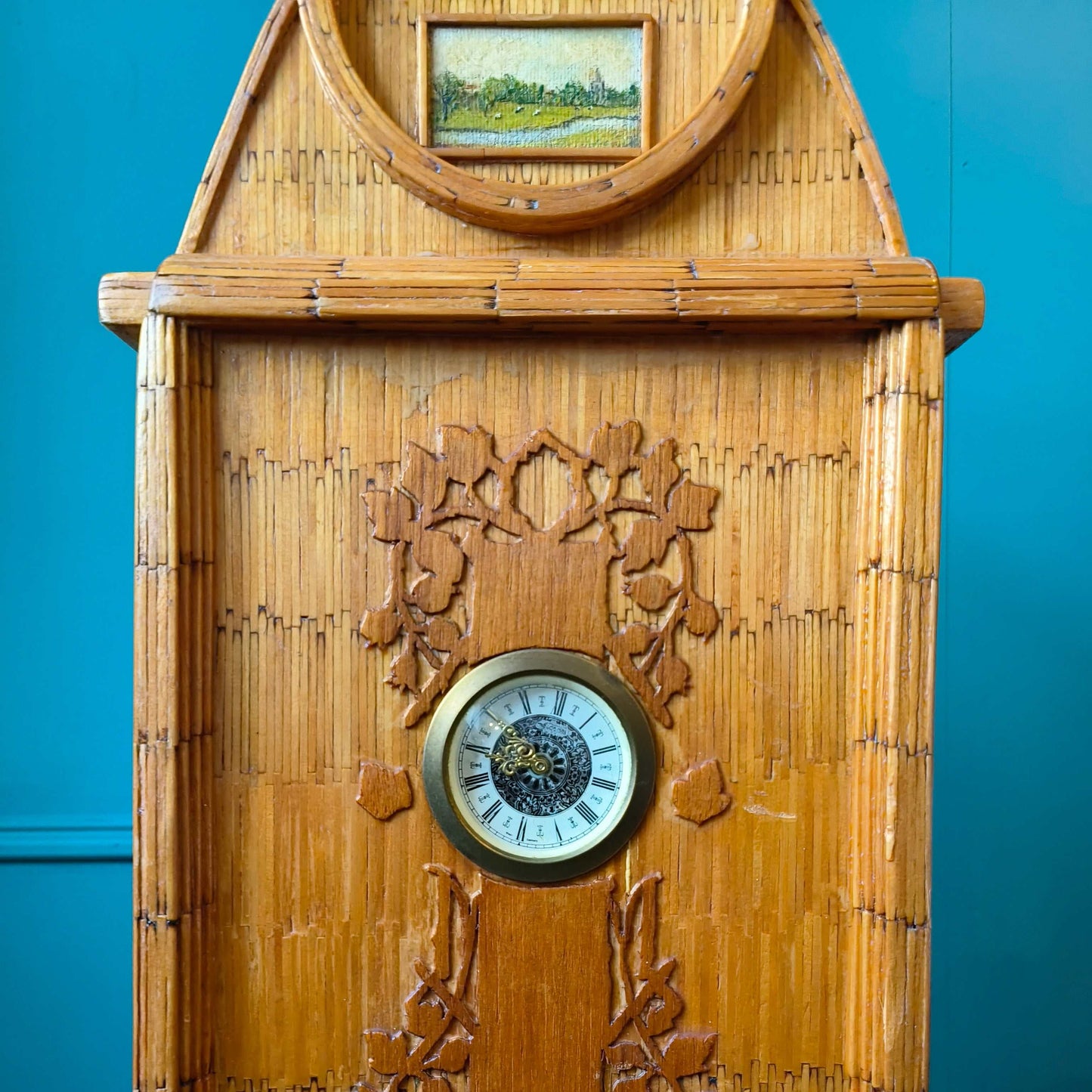 Likely German Mid-century. Constructed from matchsticks with a working clock and a drawer at the base.
Features a decorative horse figure on the very top.
Intricate jail-style folk Art.